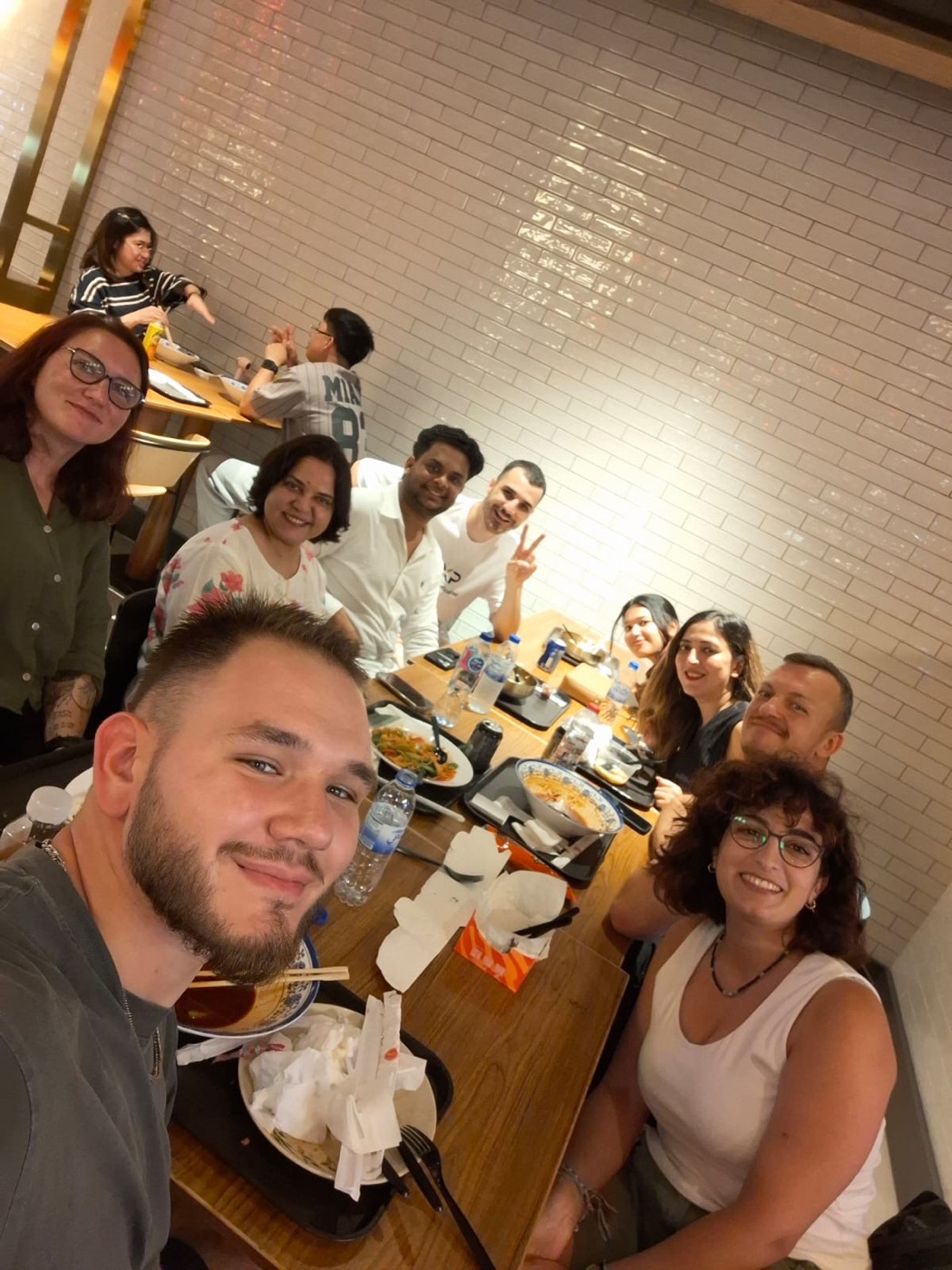 WorldXpat members taking a selfie around a dinner table